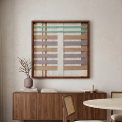 Large square Sleeping Flora fiber wall art featuring pastel mint, lavender, and taupe hand-woven patterns hanging above a dark wood sideboard in a serene living space.