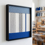Side profile of the framed soft cotton cord wall art in a workshop setting, showcasing the depth and dimensional layered winding technique.
