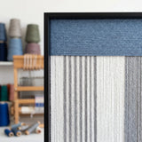 Close-up of the soft cotton cord texture and black frame corner, highlighting the high-quality blue and white yarn craftsmanship.