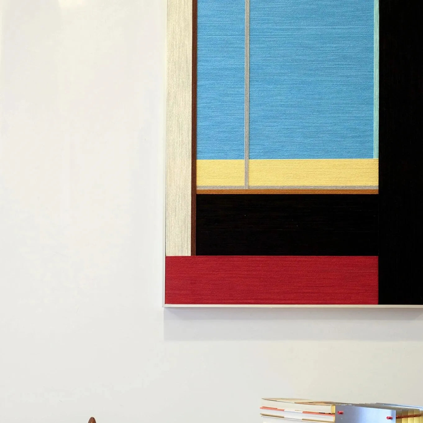 Macro close-up of After the Beach Walk yarn wall art revealing looped wool texture and crisp transitions between blue, gold, red, and black panels