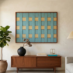 Landscape orientation hand-woven wool wall art with teal and yellow checkered patterns hanging above a mid-century walnut sideboard.