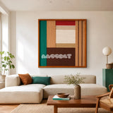 Autumn Breeze geometric yarn wall art displayed above a cream sectional sofa in a warm modern living room.