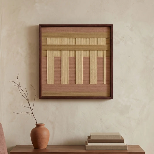 A diptych set of square hand-woven wool wall art in black frames, featuring minimalist black and cream geometric abstract patterns with sage green accents, hanging above a dark wood console.