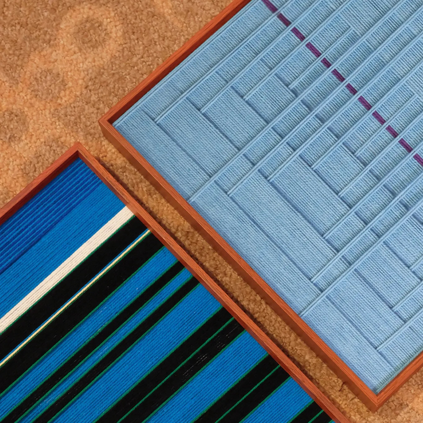 Blue Bridge Over the Pond yarn wall art displayed on a shelf with minimal décor, highlighting the grid panel and solid blue section contrast