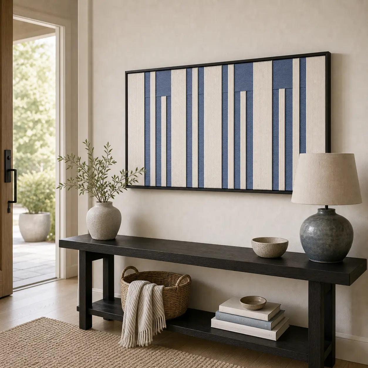 Striking Blue Cadence framed wall art styled in a bright entryway, hanging above a sleek black console table with vases.