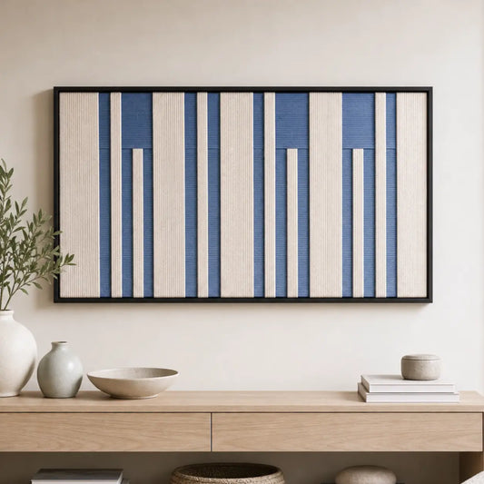 The Blue Cadence hand-woven wool tapestry styled above a minimalist light wood console table with decorative ceramics.