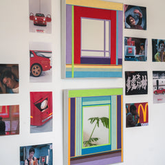 Bohemian Reverie yarn mirror art hung alongside framed prints on a living‑room wall for a curated gallery look.