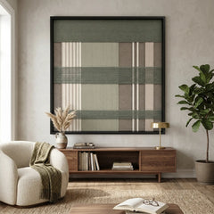 Earth-toned Celadon Mist framed wall art styled elegantly above a dark wood mid-century credenza next to a white armchair draped with a green throw blanket.
