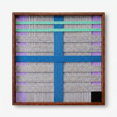 Frontal studio shot of the Cobalt Window hand-woven wool wall art featuring a bold blue cross and mint green stripes in a wooden frame against a clean white background.
