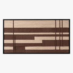 Frontal studio shot of the Cocoa Grid hand-woven wool wall art featuring brown and cream geometric grid patterns in a black frame.