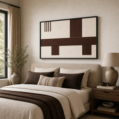 Large framed Cocoa Horizon wool tapestry hanging elegantly above a neatly styled bed with matching brown bedding in a cozy room.