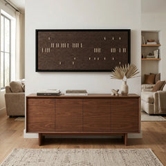 The Cocoa Whispers hand-woven wool tapestry provides a stunning minimalist focal point over a mid-century modern wooden credenza in a bright, airy room.