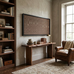 Earth-toned Cocoa Whispers framed wall art styled in a cozy study area, positioned above a sleek wooden console table next to a brown leather armchair.