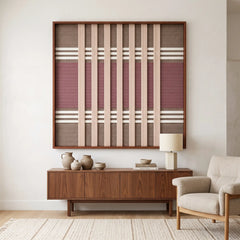 The Dusty Tones hand-woven wool tapestry hangs elegantly above a wooden sideboard in a cozy living room with neutral-colored furniture.
