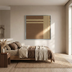 Modern hand-woven wool wall hanging styled above a platform bed with brown linens, creating a cozy and organic bedroom aesthetic.