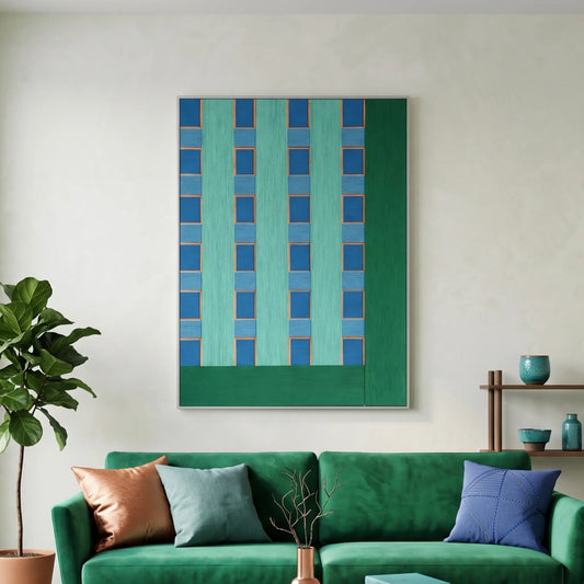 Hand-woven wool wall art with vibrant teal and blue geometric patterns hanging above a plush green sofa in a tropical modern living room.