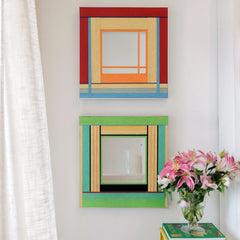 Two variations of the Fields of Blossoms woven mirror collection hanging vertically, comparing the red and green colorway options.