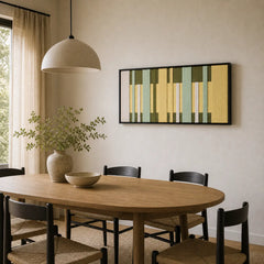 Green and yellow geometric hand-woven wool tapestry beautifully staged in a bright dining room over a wooden oval table.