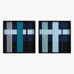 Frontal studio shot of the Glacial Stationeries textile art pair, showcasing two matching square hand-woven wall art pieces with icy blue and navy geometric designs in black frames.