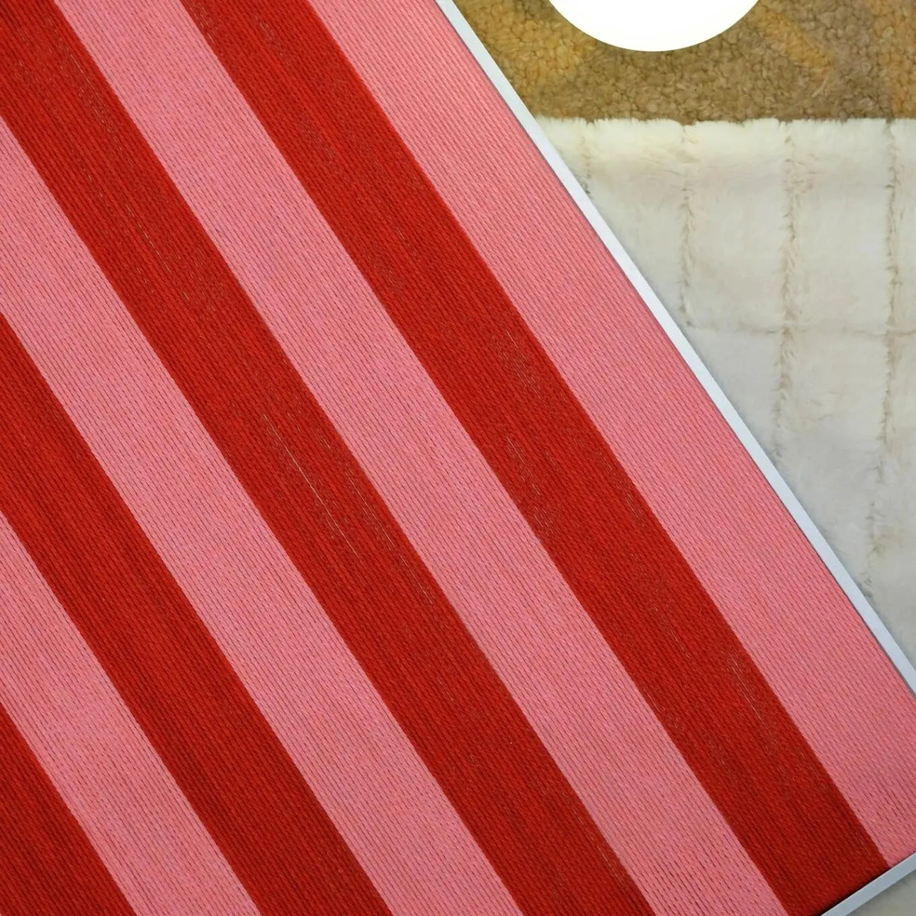 Detailed close-up of the yarn weave on Hana & Alice wall art, showing tight stitching and vibrant red color depth