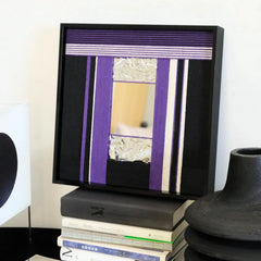 Hand-held view of HOUTIAN yarn mirror wall art showing its compact square frame, crisp stripe weave, and reflective center.