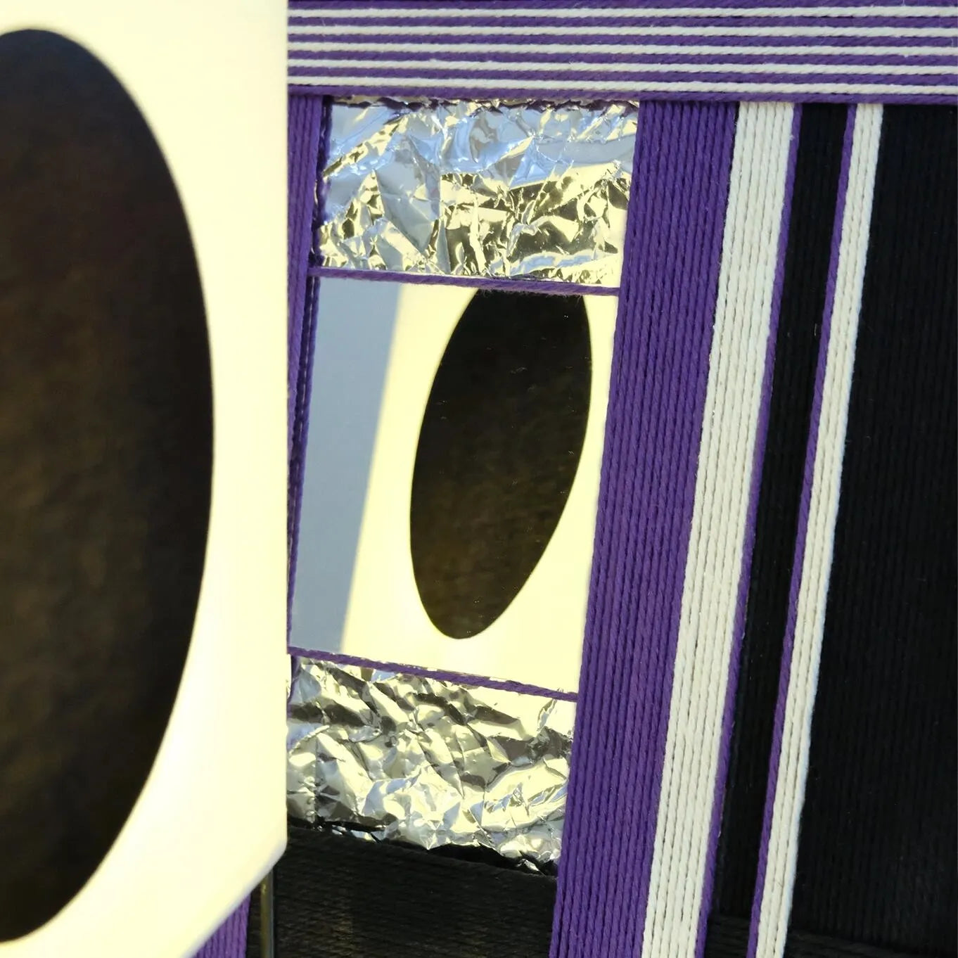 Close-up of HOUTIAN yarn mirror art border revealing tight looped wool texture and the seamless edge between yarn and mirror glass.