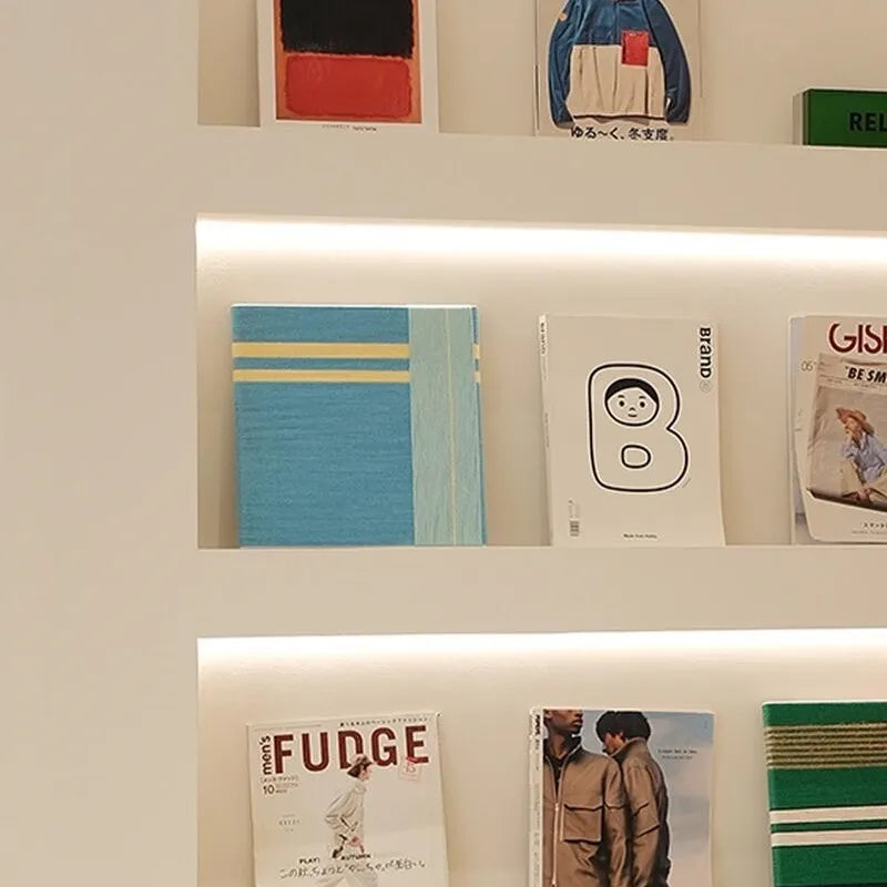 Infinite Serenity yarn woven wall art displayed on a shelf alongside books and decor pieces, highlighting its tranquil blue and yellow stripe composition