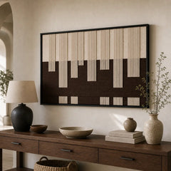 Striking hand-woven wool tapestry positioned perfectly above a sleek wooden console table adorned with a modern lamp.