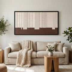 The Ivory Rhythm hand-woven wool tapestry provides a warm focal point over a cozy beige sofa in a modern, sunlit living room.