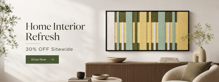 A curated modern living room interior banner promoting a 'Home Interior Refresh' sale. The image features a large abstract textile wall art piece (with mint, yellow, and white stripes) in a black frame, mounted above a fluted wood console table. Vases, books, and bowls decorate the surfaces. Text on the left reads 'Home Interior Refresh', '30% OFF Sitewide', and a green 'Shop Now' button.