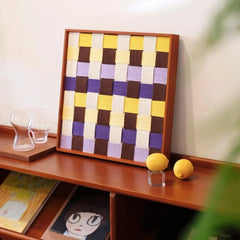 Mrs Dalloway yarn art displayed on a console shelf with curated decor items.