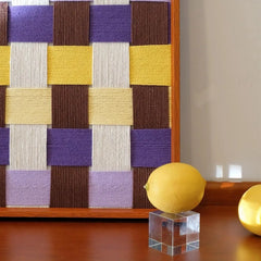 Close-up of the geometric yarn texture and wooden frame of Mrs Dalloway wall art.