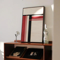 “Napoli” yarn wall art styled on a tabletop with minimal decor to emphasize its bold stripe pattern and precise square format