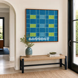 North Sea Poem ocean blue, sky blue, and lime green geometric yarn wall art displayed above a woven bench in a modern entryway.