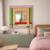 Olive Tree Romance colorful yarn-framed mirror displayed above a sage cabinet beside a pink bed in a modern bedroom.