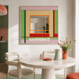 Olive Tree Romance green, blush, beige, orange, and red yarn-framed mirror displayed above a round table in a modern dining room.