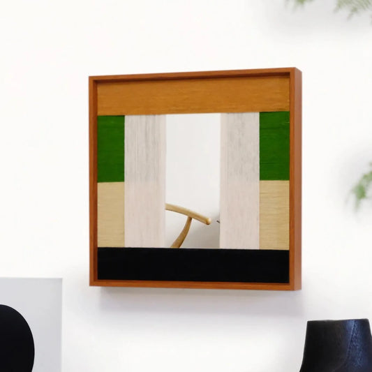 Pastoral Elegance hand-woven wool yarn wall art with alternating emerald green and creamy beige panels, framed in natural wood, styled above a console table