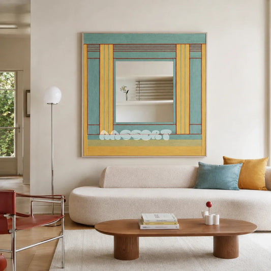 Pear Blossom Tree aqua, golden yellow, and rust yarn-framed mirror displayed above a cream sofa in a bright modern living room.