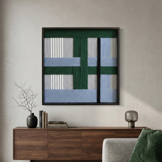 Large square "Polar Forest" fiber wall art with green and blue hand-woven wool patterns hanging above a dark wood sideboard in a modern living room.