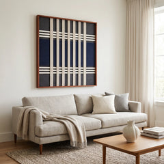 Large Polar Meridian hand-woven wool tapestry hanging elegantly above a comfortable sofa in a bright, modern living room setting.