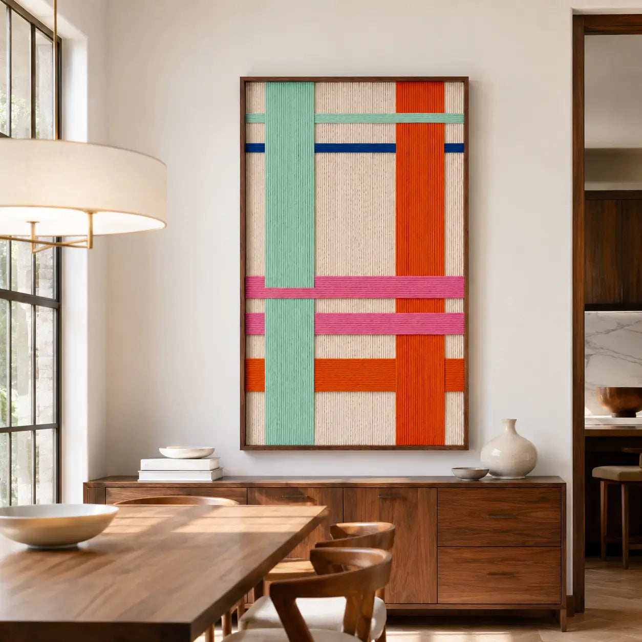 Sophisticated dining room interior showcasing the hand-woven wool tapestry mounted on a textured wall near a modern wooden dining table set and chic pendant lights.