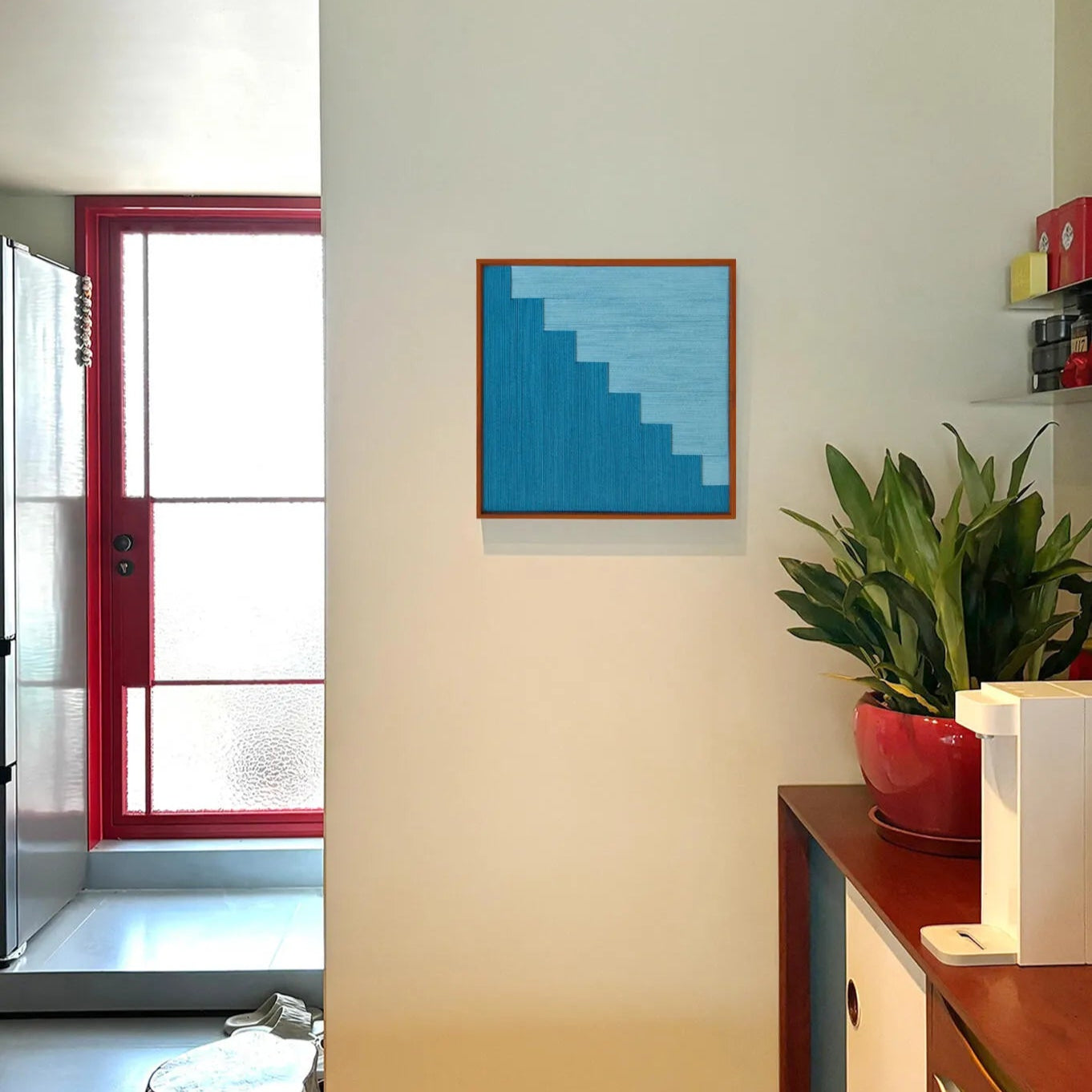 Radiant Azure wall art styled on a desk with vase and books, adding a pop of tranquil color to a modern workspace