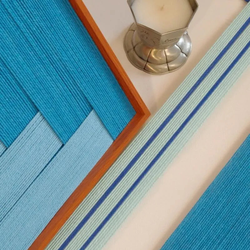 Close-up of wool yarn texture on Radiant Azure wall art, revealing tight weave and rich azure tones