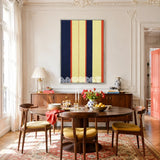 Twilight Rush RE016 framed textile art with deep navy, royal blue, light blue, red, and yellow geometric yarn displayed in a modern interior.