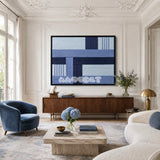 Nordic Tide RE028 framed textile art with pale blue, deep navy, periwinkle, and cool white geometric yarn displayed in a modern interior.
