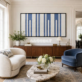 Blue Cadence RE031 panoramic framed textile art with ivory and muted denim blue vertical yarn bands displayed in a modern interior.