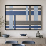 Slate Harbor RE033 blue and gray geometric textile wall art displayed above a wooden sideboard in a bright dining room.
