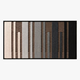 Front studio view of Umber Columns textured wall art featuring vertical grey, brown, black, and cream stripes in a black frame.