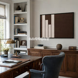 Framed Timeless Trace woven wall hanging with cream and brown geometric blocks in a refined neutral room.
