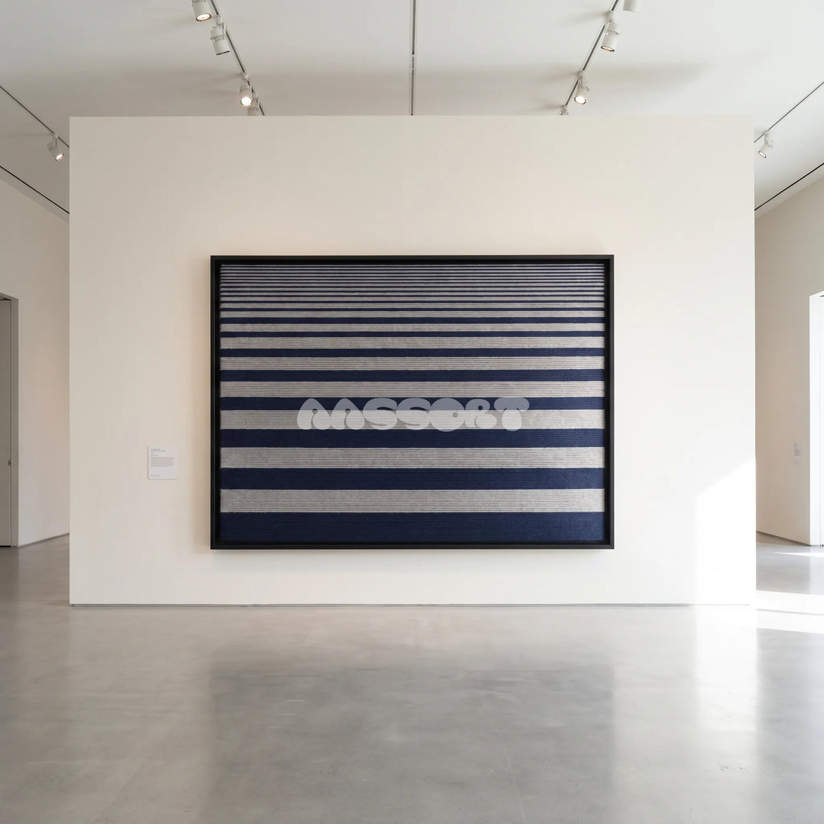 View of Linear Gradient framed textile wall art, featuring navy blue and light grey horizontal cotton cord stripes graduating from fine to broad bands.